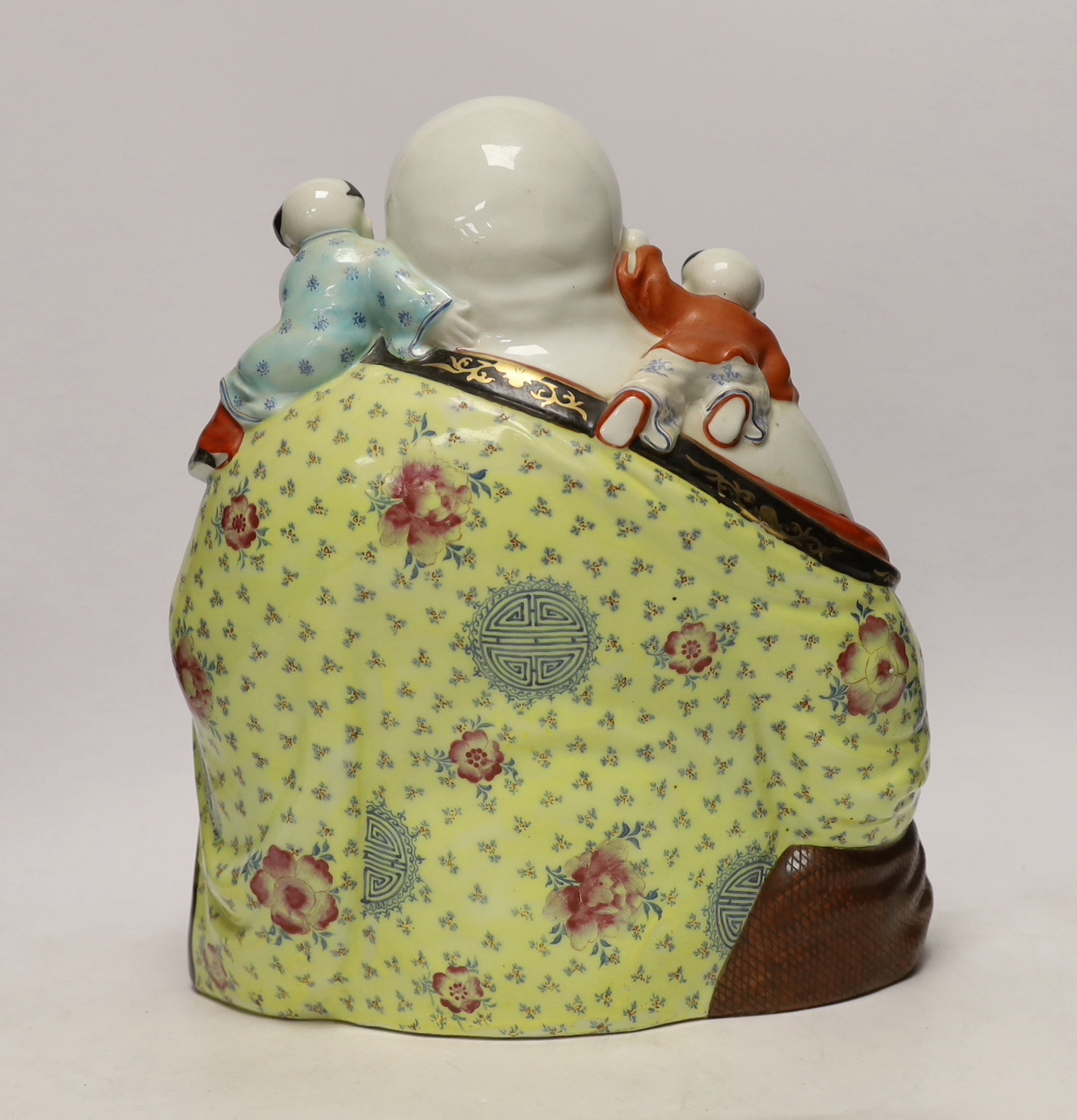 A Chinese enamelled porcelain group of laughing Budai with children, mid 20th century, 31cm high